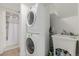 A laundry area featuring a stacked washer and dryer and a utility sink at 2348 Sherman St, Longmont, CO 80501