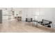 Bright living room/dining area with light wood floors, modern chairs, and open layout at 2348 Sherman St, Longmont, CO 80501