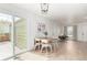 Bright living room/dining area with light wood floors, modern chairs, and sliders to the private patio at 2348 Sherman St, Longmont, CO 80501