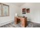Home office space with a wooden desk, chair, and decorative wall art at 2348 Sherman St, Longmont, CO 80501