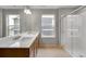 Modern bathroom features dual sinks with a spacious countertop and a glass-enclosed shower at 14239 Beebalm Ave, Parker, CO 80134