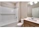 The bathroom features a tub shower, white subway tile, modern vanity, and a brushed nickel faucet at 14239 Beebalm Ave, Parker, CO 80134