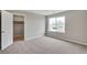 Bright bedroom boasts plush carpeting, neutral tones, and a large window providing natural light at 14239 Beebalm Ave, Parker, CO 80134