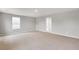 Large bedroom boasts neutral tones, plush carpeting, and an entrance leading to the walk-in closet at 14239 Beebalm Ave, Parker, CO 80134