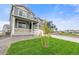 Beautiful two-story home on a green lawn with stone accents, complemented by a porch at 14239 Beebalm Ave, Parker, CO 80134