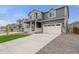 Charming two-story home with a long driveway leading to an attached two-car garage at 14239 Beebalm Ave, Parker, CO 80134