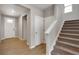 Bright foyer with hardwood floors, a staircase, and a white front door with glass inserts at 14239 Beebalm Ave, Parker, CO 80134