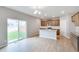 Bright eat-in kitchen boasts a granite island, stainless appliances, and sliding doors to the backyard at 14239 Beebalm Ave, Parker, CO 80134