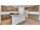 This kitchen features granite countertops, wood cabinets, a large island, and stainless steel appliances at 14239 Beebalm Ave, Parker, CO 80134