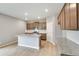 The bright kitchen is equipped with stainless appliances, recessed lights, granite countertops and a large island at 14239 Beebalm Ave, Parker, CO 80134
