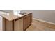 Close-up of the kitchen island showcasing the granite countertop, double sink, and a stainless steel dishwasher at 14239 Beebalm Ave, Parker, CO 80134