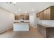 Modern kitchen featuring granite countertops, wood cabinets, a large island, and recessed lighting at 14239 Beebalm Ave, Parker, CO 80134