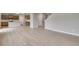 Spacious open-concept living area featuring hardwood floors and a modern kitchen in the background at 14239 Beebalm Ave, Parker, CO 80134