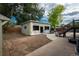 Large backyard view with a unfinished structure, wooden fence, and stairs to a deck at 772 Lewiston St, Aurora, CO 80011