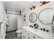 Modern bathroom featuring double sinks, subway tile shower, updated fixtures, and neutral decor at 772 Lewiston St, Aurora, CO 80011