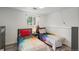 Bright bedroom with two beds and unique paint-splattered bedding at 772 Lewiston St, Aurora, CO 80011
