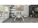 Elegant dining area featuring a glass-top table, modern decor, and ample natural light at 772 Lewiston St, Aurora, CO 80011