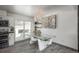Stylish dining area with a glass dining table, modern lighting, and seamless access to an outdoor deck at 772 Lewiston St, Aurora, CO 80011