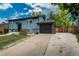 Charming two story home with front yard, driveway, and manicured lawn at 772 Lewiston St, Aurora, CO 80011