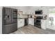 Contemporary kitchen featuring sleek black appliances, white cabinetry, and granite countertops at 772 Lewiston St, Aurora, CO 80011