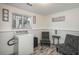 Bright laundry room with washer, stylish seating, and decor at 772 Lewiston St, Aurora, CO 80011