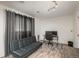 This versatile living area boasts a modern gray sofa bed and a functional work space at 772 Lewiston St, Aurora, CO 80011