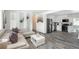 Open-concept living room and kitchen featuring a comfortable seating area and modern appliances at 772 Lewiston St, Aurora, CO 80011