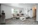 Comfortable living room showcasing neutral tones, modern decor, and natural light through the window at 772 Lewiston St, Aurora, CO 80011