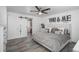 A spacious main bedroom has wood-look floors, a ceiling fan, and stylish decor on the wall at 772 Lewiston St, Aurora, CO 80011