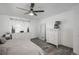 A bright main bedroom features white walls, wood-look floors, a ceiling fan, and white dressers at 772 Lewiston St, Aurora, CO 80011