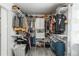 This walk-in closet is well-organized with shelves and rods for ample storage and a laundry basket at 772 Lewiston St, Aurora, CO 80011