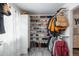 A walk-in closet with shelves and racks is full of clothes and shoes for plenty of storage at 772 Lewiston St, Aurora, CO 80011