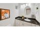 Well-lit half-bath with white cabinets, granite countertop, and modern fixtures at 11263 Vrain Dr, Westminster, CO 80031