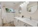 Bathroom featuring a double vanity with new fixtures and a framed mirror at 11263 Vrain Dr, Westminster, CO 80031
