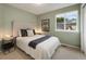 Cozy bedroom featuring neutral walls, a comfortable bed, and a window with natural light at 11263 Vrain Dr, Westminster, CO 80031