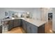 Spacious kitchen features an expansive island with barstool seating, sleek countertops, and hardwood floors at 11263 Vrain Dr, Westminster, CO 80031