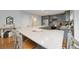 Spacious kitchen with a large island featuring grey cabinetry and stainless steel appliances at 11263 Vrain Dr, Westminster, CO 80031