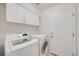 Laundry room featuring a white washer and dryer and white cabinets at 11263 Vrain Dr, Westminster, CO 80031