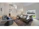 Open-concept living room showcasing a cozy seating area, a large rug, and a view of the staircase at 11263 Vrain Dr, Westminster, CO 80031