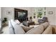 Cozy living room featuring a large sofa, bay windows, and a custom built-in entertainment center at 11263 Vrain Dr, Westminster, CO 80031