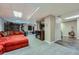 Finished basement with a comfortable red couch and laminate flooring at 11710 Crow Hill Dr, Parker, CO 80134