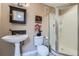 Bathroom featuring pedestal sink and shower with glass doors at 11710 Crow Hill Dr, Parker, CO 80134