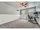 Spacious bedroom/office with paneled walls, neutral colors, and bright, natural light at 11710 Crow Hill Dr, Parker, CO 80134