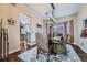 Dining room featuring hardwood floors, an area rug, and a hanging light fixture at 11710 Crow Hill Dr, Parker, CO 80134