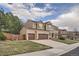 Charming two-story brick home with a manicured front yard and an attached two-car garage at 11710 Crow Hill Dr, Parker, CO 80134