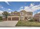 Charming two-story brick home with a manicured front yard and an attached two-car garage at 11710 Crow Hill Dr, Parker, CO 80134
