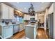 Bright kitchen with white cabinets, granite countertops, stainless steel appliances, and hardwood floors at 11710 Crow Hill Dr, Parker, CO 80134