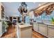 Open-concept kitchen with white cabinets, granite countertops, hardwood floors, and stainless appliances at 11710 Crow Hill Dr, Parker, CO 80134