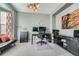 Well-lit office features a desk, comfortable seating, and ample storage space at 11710 Crow Hill Dr, Parker, CO 80134