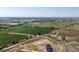 Vast aerial perspective showcasing picturesque lakes, expansive farmland, and a charming neighborhood below at 14025 Florence Ct, Brighton, CO 80602